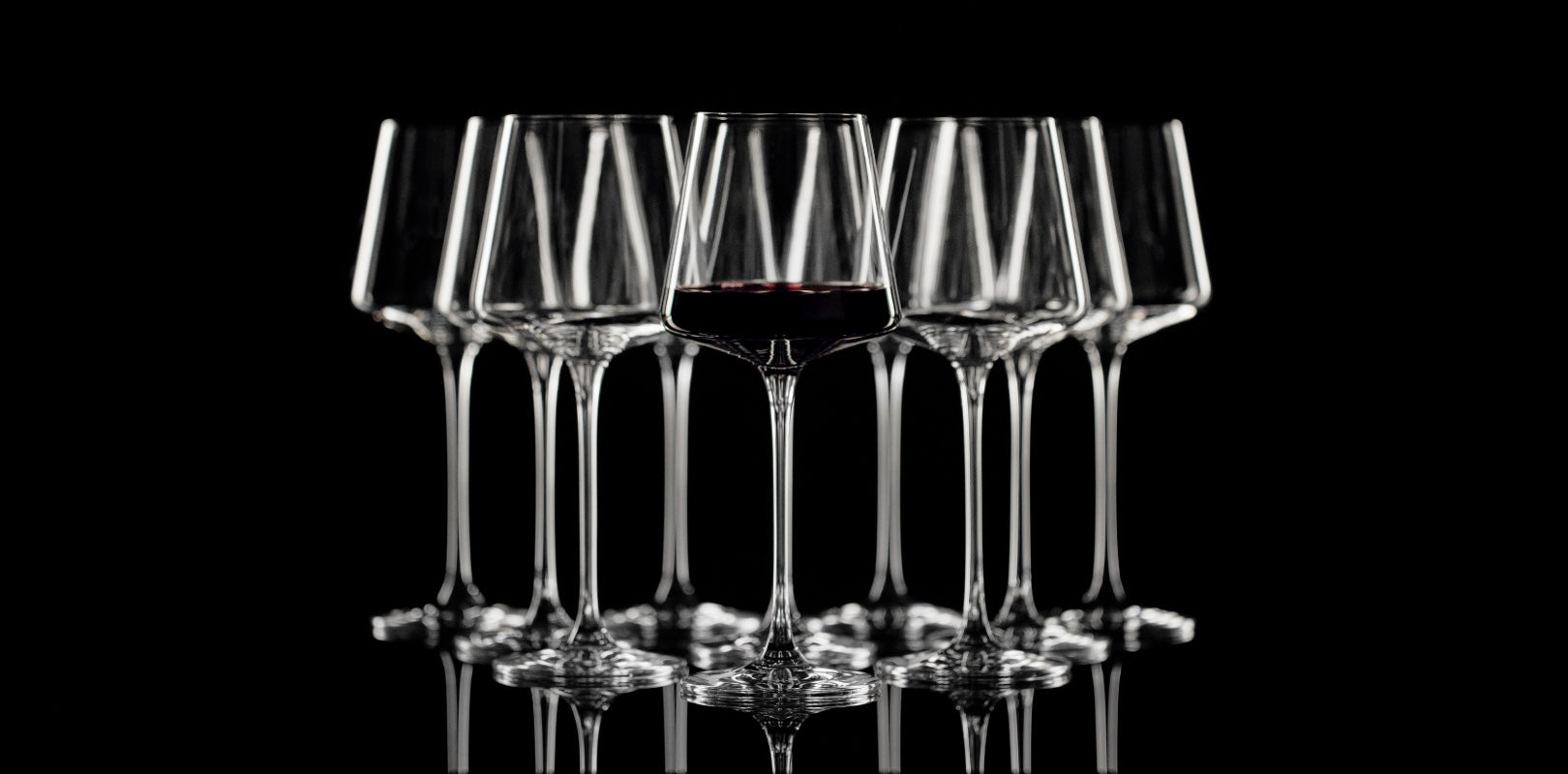 Multiple wine glasses with only one filled