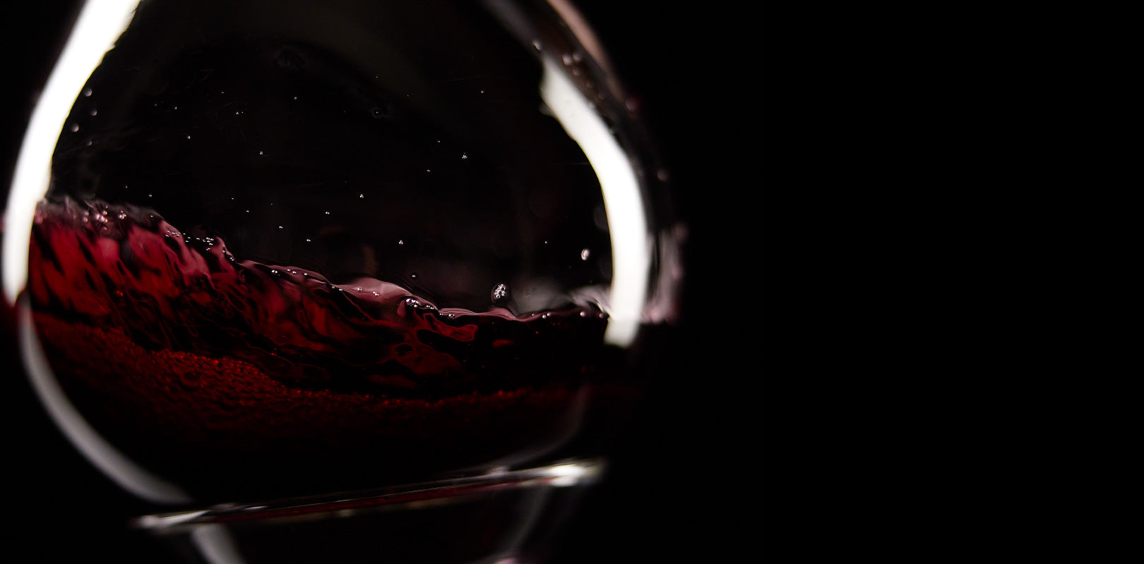 Decanter filled with swirling red wine